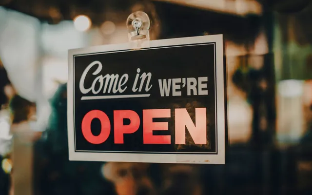 A small local business storefront with an open sign